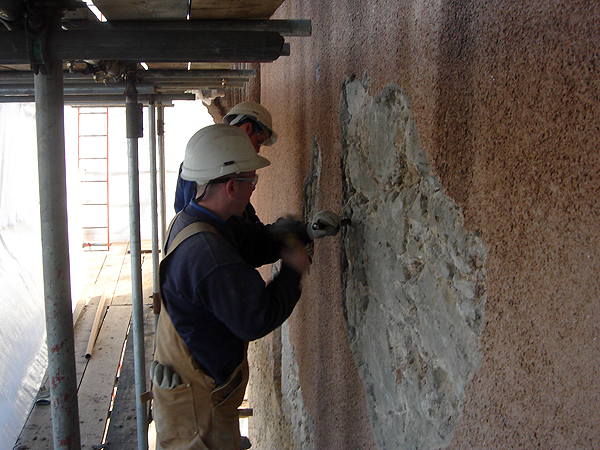 Craigievar Castle: Masons removing cement harl.
