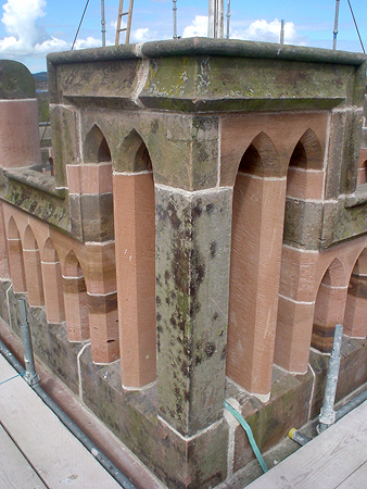 Tower parapet: replacement mullion and double headed hood to parapet.