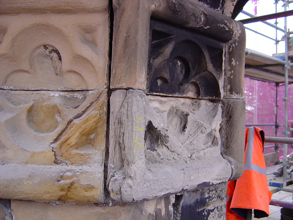 Before works: deterioration of quatrefoil panel below the buttress pinnacle.