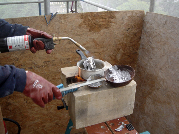 Molten lead used to lock masonry together in situ.