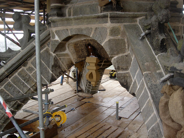 Sandstone crocket in position with ashlar repointing.