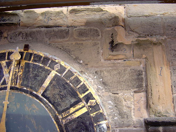 Before works: deterioration in protective hood moulding to clock face.